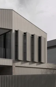 Modern building facade featuring metallic cladding and vertical paneling