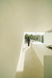A modern interior designed with minimalist white planes and a seamless layout.