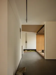 A minimalist interior space featuring concrete flooring and walls.