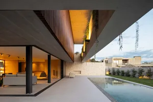 Modern minimalist residential entrance featuring concrete and wood materials.