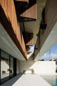 Contemporary residential architecture featuring wooden, concrete, and glass elements.