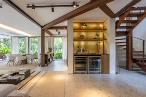 Contemporary residential kitchen with wood accents, glass doors, and metal fixtures.