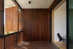 An indoor balcony featuring wooden slats and industrial-style decor.
