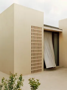 Modern minimalist architectural design featuring a concrete window with a light-colored curtain.