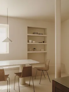 Minimalist living room with marble table and woven chairs