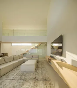 Modern minimalist living room with neutral color palette and a large sectional sofa.