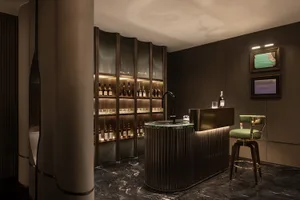 Modern bar area featuring metal shelving and marble countertop