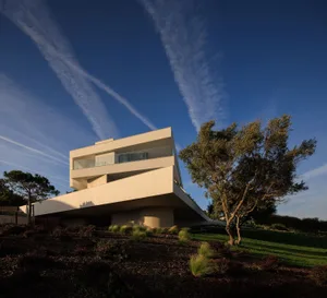 A modern, concrete house with a unique architectural design.