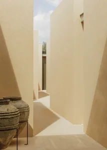 Modern minimalist architecture featuring textured, beige concrete walls.