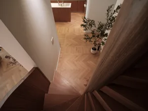 An image showcasing a modern wooden staircase in an interior setting.