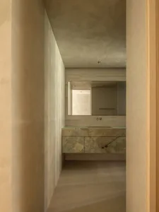 Minimalist bathroom featuring a marble countertop and sink.