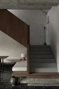 Modern interior design featuring concrete tiling and wooden elements.