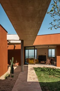 Modern outdoor living space with concrete materials and a view of the landscape.