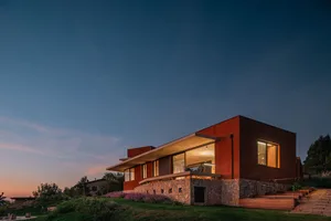 A modern residential house with clay bricks exterior during dusk.