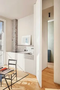 A contemporary residential kitchen featuring minimalist design elements and concrete finishes.