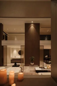 Modernist living room featuring a minimalist design with a brown color palette, including furniture, walls, and decorative el