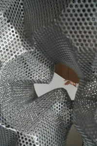 A modern interior design featuring metallic mesh material.