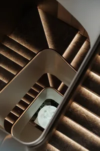 Modern staircase crafted from concrete, featuring sleek lines and warm lighting.
