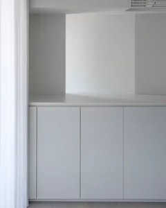 A minimalist interior space with concrete walls and floor.