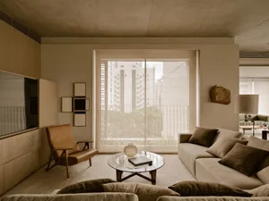 A minimalist living room featuring neutral-toned furniture and decor.
