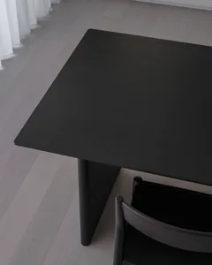 A black wooden table with a sleek, minimalist design.