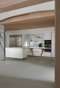 Modern kitchen featuring a marble island and white cabinetry.