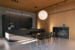 Modern living room featuring black metallic furniture and wooden walls.