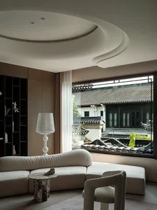 Modern living room with cozy, soft textiles and contemporary furniture.