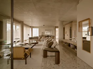 Modern living room featuring terrazzo flooring and minimalist furniture.