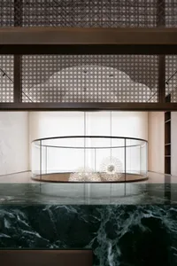 Modern lobby interior featuring glass chandeliers suspended from the ceiling.