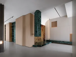 Modern lobby interior with marble and concrete elements.