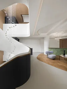 Modern lobby interior featuring a white glass and wood spiral staircase.