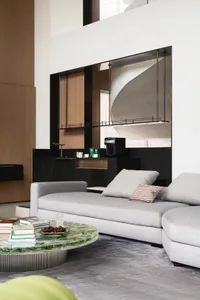 Modern living room with marble coffee table, fabric sofa, and metal accents