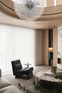 A modern minimalist lounge area featuring marble and glass elements.