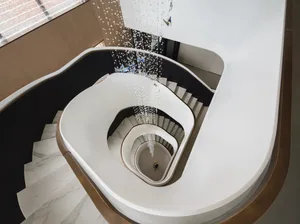 Staircase with modern design featuring marble material and decorative elements.