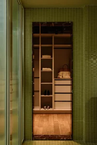 Modern closet storage area with wood tiles and marble accents, featuring organized shelves and drawers.