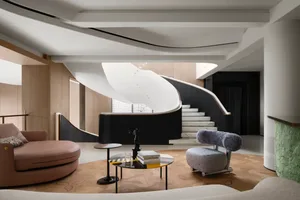 A well-designed modern interior living room featuring wooden panels, leather textiles, and marble flooring.