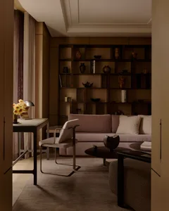Modern living room featuring fabric seating, metal accents, and wooden elements.