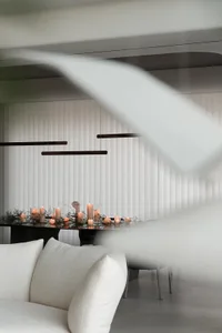 A minimalist dining room adorned with candles and fabric elements.