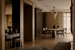 Modern dining room featuring marble columns, wooden dining table, and minimalist pendant light.