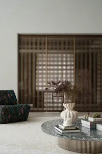 A modern living room featuring a metal frame netting structure and a marble coffee table.