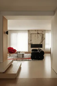 A modern living room featuring wooden flooring, marble accent wall, and vinyl flooring.