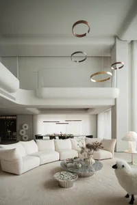 Modern living room with neutral-toned couches, coffee tables, and decorative accents.