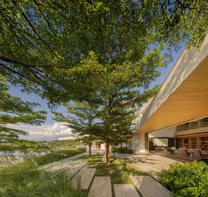 Modern residential exterior featuring a combination of concrete and wooden elements.