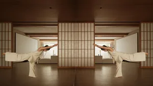 A person practicing yoga on wooden flooring in a spacious studio with wooden dividers.