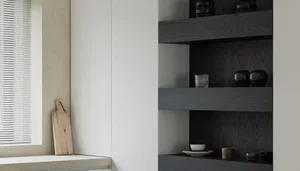 A minimalist kitchen featuring wooden shelves, glass vases, and concrete countertops.