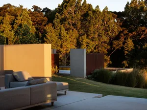 Modern concrete and steel exterior design featuring natural greenery.