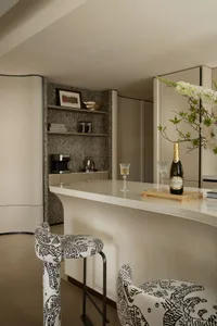 A sleek modern kitchen bar in a contemporary style, featuring minimalist white finishes and clean lines.