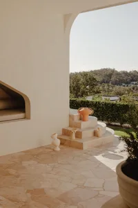 Moderately sunlit modern minimalist terrace featuring stone and terracotta elements.