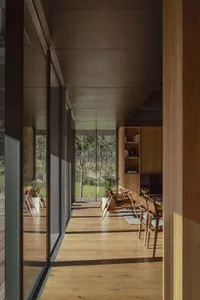 A modern residential dining room with wooden finishes.